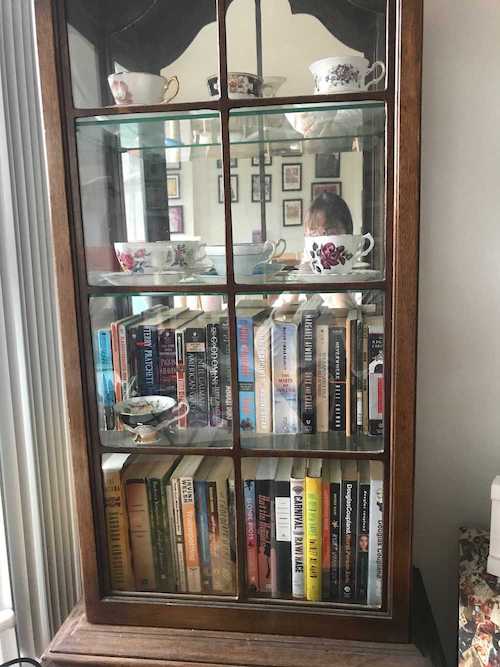 A bookshelf with teacups